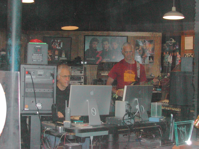 Tom, Bill behind the glass